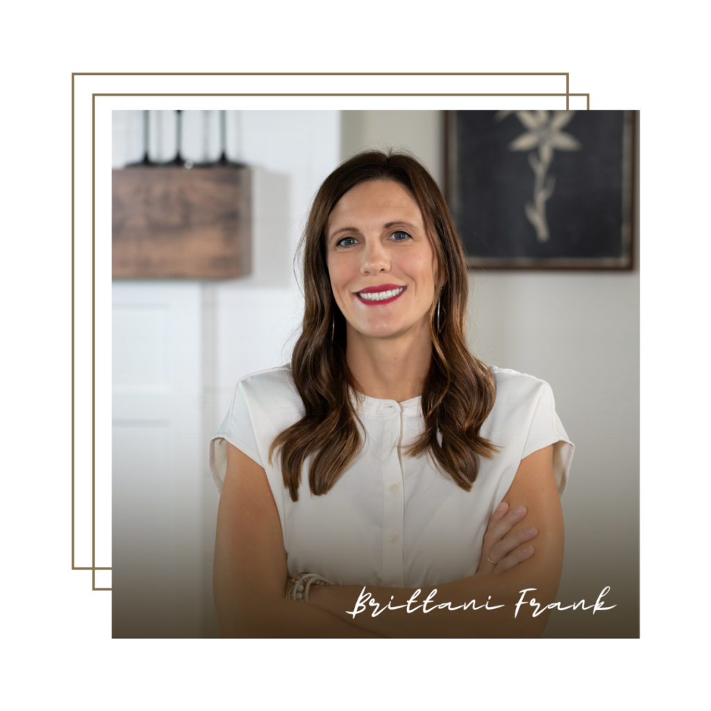 A woman with long brown hair, wearing a white blouse, stands smiling with arms crossed in a modern, softly lit room. Decorative lines frame the photo, and “Britani Frank” appears at the bottom alongside a subtle "Buying Guide" tag.